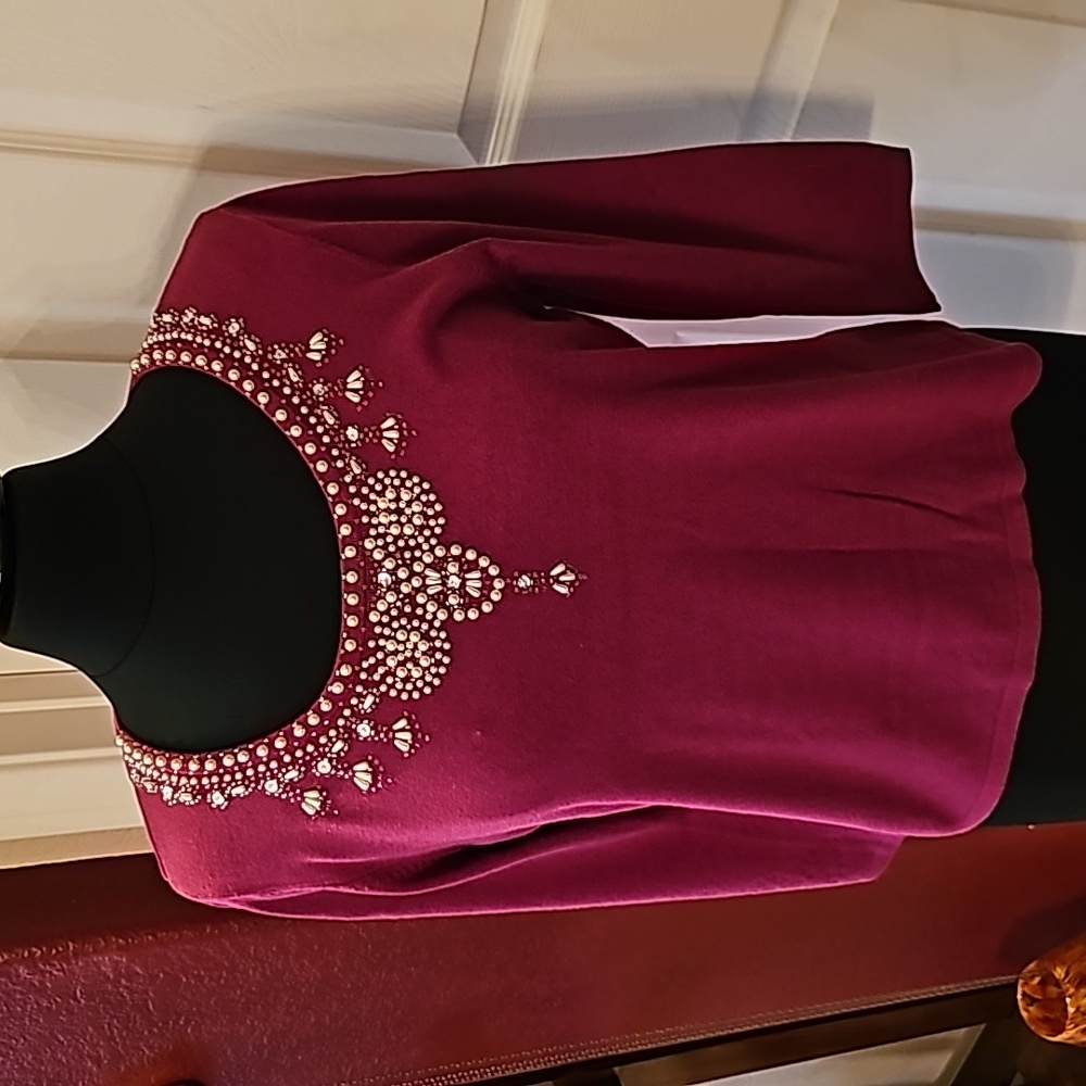 Deep pink beaded sweater.